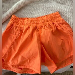 Bright orange lululemon running shorts